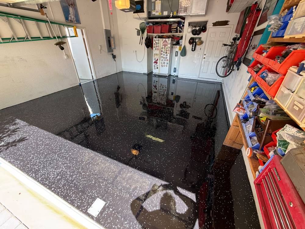 Garage with glossy black epoxy floor and white flakes