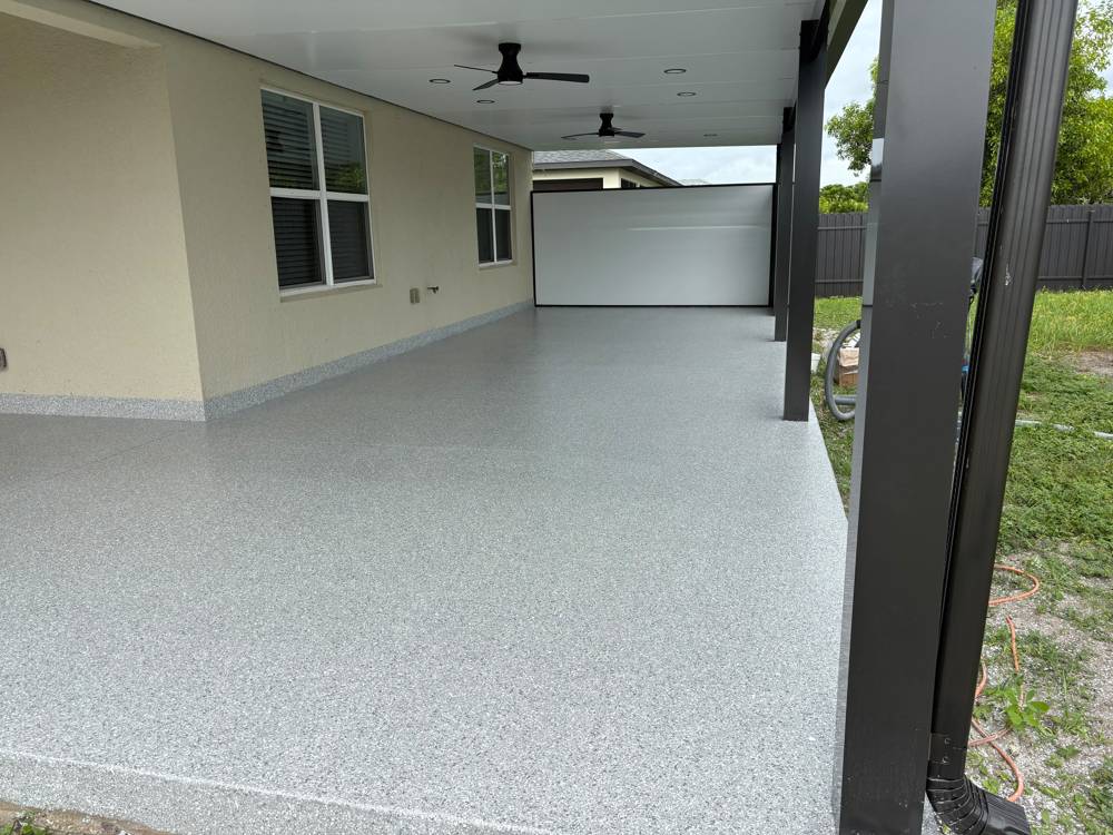 Covered patio with gray epoxy flake floor after