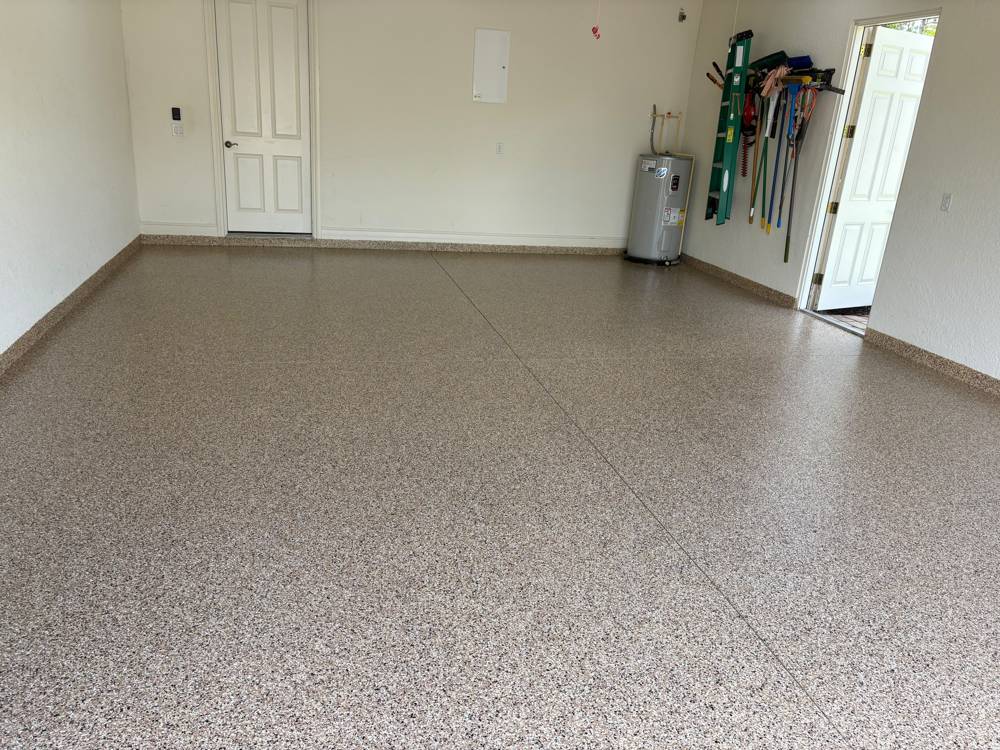 Garage with tan epoxy flake floor and cove base